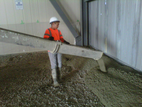 worker pouring concrete